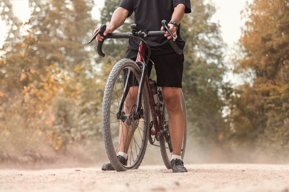 Cyclist,With,A,Gravel,Bicycle,On,A,Dusty,Country,Road.