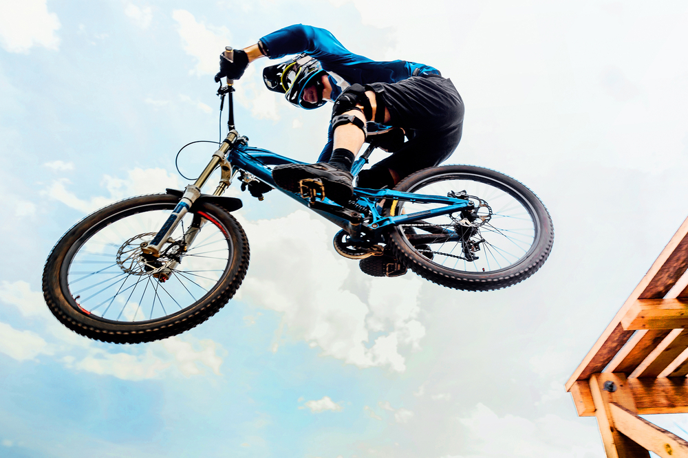 Cyclist,Drops,On,Jump,Downhill,Mountain,Biking