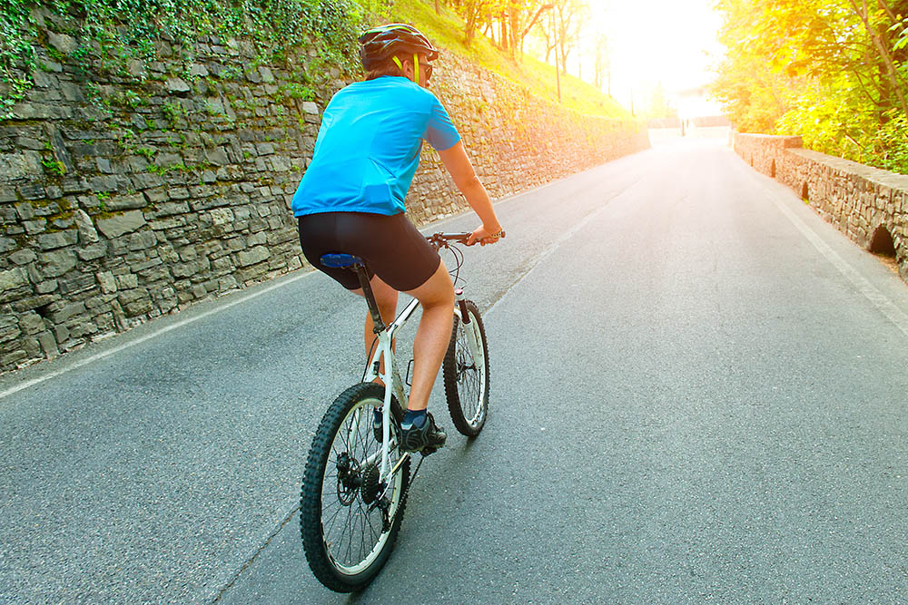 Where should I sit on my bike saddle? When it comes to cycling, there are a few things that can impact how comfortable you find a bike: from the material it’s made out of, to the fit of the bike. However, without a doubt, the saddle, and where you’re sitting on it, is going to have the biggest impact on your comfort. Sitting incorrectly on a saddle can not only cause discomfort, but may trigger further issues such as back pain, particularly if you’re riding for long periods. In this article, we’ll be discussing how to sit comfortably on your saddle, as well as other things to consider, such as saddle height, position, and what to look for in a good bike saddle. Where should I sit on my bike saddle? Riding positions will vary somewhat between cyclists, depending on their riding style and bike. However, generally, you should sit as far back as possible on the widest part of the saddle. What is the best seat position on a bike? The clamp connecting your saddle to the seat post should be pretty much in the center of the rails, not all the way forward or back. In terms of the angle, the seat should be level or tilted down by a few degrees at the front, but never tilt it upwards. When you’re sitting on the saddle, you should ensure that you can easily reach the tops and brake hoods on a road bike, or the grips on a mountain bike. Your elbows shouldn’t be locked, they should be slightly bent, and you should engage your core to support your torso as it leans forward in a comfortable position. There should be no need to slide forward or backward on the seat. Other factors which will affect your comfort The size of your bike If your bike isn’t the right size for you, you’ll struggle to sit comfortably on the saddle. Bike frames are measured based on the height of your pubic bone, which is similar to your inseam measurement. To find out yours, use a measuring tape to measure the distance from your pubic bone to the base of your heel along the inside of your leg. Once you know your pubic bone height, you can then find out what size bike you need using a manufacturer's size chart. If you’re between two sizes, go for the smaller one, as you can easily make up the difference by adjusting your seat height. Saddle height If you’re finding your bike saddle uncomfortable, it could be that your saddle height needs adjusting. To find the ideal seat height for you, lean the bike against a wall and mount it in place. Then, use an Allen key or the quick release to adjust the height so it’s hip-height, or so your knee is slightly bent when the pedal is at its lowest point when you’re pedaling. The reason for this is that you want some bend in your knee so that you’re not straining to reach the pedals, but equally you don’t want to bend too much as this will be less efficient and will take its toll on your joints. Ride in the right position When you cycle, you should lean forward so that your body forms a triangle shape, with your arms leaning forward to meet the handlebars and your head at the apex. This allows you to distribute weight between your sit bones and your hands, while your back absorbs the vibration and jarring but without straining. Your elbows should be slightly bent, with your neck and shoulders relaxed. If you feel like you’re overstretching to reach the handlebars and the various positions on the drop bars, you may need to adjust the height of your handlebar stem. Get a proper bike fit It’s a good idea to get a proper bike fit, as this way a professional bike fitter will be able to ensure your handlebars, saddle height, and saddle position are tailored to your height. This will not only ensure you’re more comfortable on your bike but will also allow you to ride more efficiently. Choosing the right saddle If you’ve done all of the above, and you’re still not finding your bike comfortable, it could be that the saddle just isn’t right for you. Choosing the right saddle for you depends on a few different things, but you’ll mainly want to tailor your saddle to the type of riding you’ll be predominantly doing. For example, experienced riders who are cycling in an ‘aggressive’ position will require a thinner, more aerodynamic saddle with a narrow nose and quick flare to allow them to sit back on their sit bones. These riders will also need more soft tissue relief, which can be found in the shape of a saddle with a cutout or relief channel. Those riding trails will need more pressure relief at the front, which can be found in saddles with a split nose design or short nose. People riding in a more upright position will need plenty of sit bone support and plenty of padding for additional comfort. General tips for comfortable riding Try riding in a more upright position Avoid riding with a heavy backpack More pedal pressure reduces the pressure from the saddle Look at reducing body weight if necessary, as this reduces pressure from the saddle Use a thinner saddle padding Sit as far back as possible on the widest part of the saddle Adjust the saddle angle down slightly Conclusion Your saddle holds the key to comfortable riding, and there are several things you need to think about to ensure maximum comfort. Your saddle should be the right height for your proportions, and you should be sat back on the widest part of it but still able to reach the handlebars with a slight bend in your elbows. If you’re still not finding your saddle comfortable, you should consider getting a professional bike fit, or if you’re satisfied that your saddle height and positioning are correct, you could buy a new saddle that is more ergonomic. Where should I sit on my bike saddle? When it comes to cycling, there are a few things that can impact how comfortable you find a bike: from the material it’s made out of, to the fit of the bike. However, without a doubt, the saddle, and where you’re sitting on it, is going to have the biggest impact on your comfort. Sitting incorrectly on a saddle can not only cause discomfort, but may trigger further issues such as back pain, particularly if you’re riding for long periods. In this article, we’ll be discussing how to sit comfortably on your saddle, as well as other things to consider, such as saddle height, position, and what to look for in a good bike saddle. Where should I sit on my bike saddle? Riding positions will vary somewhat between cyclists, depending on their riding style and bike. However, generally, you should sit as far back as possible on the widest part of the saddle. What is the best seat position on a bike? The clamp connecting your saddle to the seat post should be pretty much in the center of the rails, not all the way forward or back. In terms of the angle, the seat should be level or tilted down by a few degrees at the front, but never tilt it upwards. When you’re sitting on the saddle, you should ensure that you can easily reach the tops and brake hoods on a road bike, or the grips on a mountain bike. Your elbows shouldn’t be locked, they should be slightly bent, and you should engage your core to support your torso as it leans forward in a comfortable position. There should be no need to slide forward or backward on the seat. Other factors which will affect your comfort The size of your bike If your bike isn’t the right size for you, you’ll struggle to sit comfortably on the saddle. Bike frames are measured based on the height of your pubic bone, which is similar to your inseam measurement. To find out yours, use a measuring tape to measure the distance from your pubic bone to the base of your heel along the inside of your leg. Once you know your pubic bone height, you can then find out what size bike you need using a manufacturer's size chart. If you’re between two sizes, go for the smaller one, as you can easily make up the difference by adjusting your seat height. Saddle height If you’re finding your bike saddle uncomfortable, it could be that your saddle height needs adjusting. To find the ideal seat height for you, lean the bike against a wall and mount it in place. Then, use an Allen key or the quick release to adjust the height so it’s hip-height, or so your knee is slightly bent when the pedal is at its lowest point when you’re pedaling. The reason for this is that you want some bend in your knee so that you’re not straining to reach the pedals, but equally you don’t want to bend too much as this will be less efficient and will take its toll on your joints. Ride in the right position When you cycle, you should lean forward so that your body forms a triangle shape, with your arms leaning forward to meet the handlebars and your head at the apex. This allows you to distribute weight between your sit bones and your hands, while your back absorbs the vibration and jarring but without straining. Your elbows should be slightly bent, with your neck and shoulders relaxed. If you feel like you’re overstretching to reach the handlebars and the various positions on the drop bars, you may need to adjust the height of your handlebar stem. Get a proper bike fit It’s a good idea to get a proper bike fit, as this way a professional bike fitter will be able to ensure your handlebars, saddle height, and saddle position are tailored to your height. This will not only ensure you’re more comfortable on your bike but will also allow you to ride more efficiently. Choosing the right saddle If you’ve done all of the above, and you’re still not finding your bike comfortable, it could be that the saddle just isn’t right for you. Choosing the right saddle for you depends on a few different things, but you’ll mainly want to tailor your saddle to the type of riding you’ll be predominantly doing. For example, experienced riders who are cycling in an ‘aggressive’ position will require a thinner, more aerodynamic saddle with a narrow nose and quick flare to allow them to sit back on their sit bones. These riders will also need more soft tissue relief, which can be found in the shape of a saddle with a cutout or relief channel. Those riding trails will need more pressure relief at the front, which can be found in saddles with a split nose design or short nose. People riding in a more upright position will need plenty of sit bone support and plenty of padding for additional comfort. General tips for comfortable riding Try riding in a more upright position Avoid riding with a heavy backpack More pedal pressure reduces the pressure from the saddle Look at reducing body weight if necessary, as this reduces pressure from the saddle Use a thinner saddle padding Sit as far back as possible on the widest part of the saddle Adjust the saddle angle down slightly Conclusion Your saddle holds the key to comfortable riding, and there are several things you need to think about to ensure maximum comfort. Your saddle should be the right height for your proportions, and you should be sat back on the widest part of it but still able to reach the handlebars with a slight bend in your elbows. If you’re still not finding your saddle comfortable, you should consider getting a professional bike fit, or if you’re satisfied that your saddle height and positioning are correct, you could buy a new saddle that is more ergonomic.