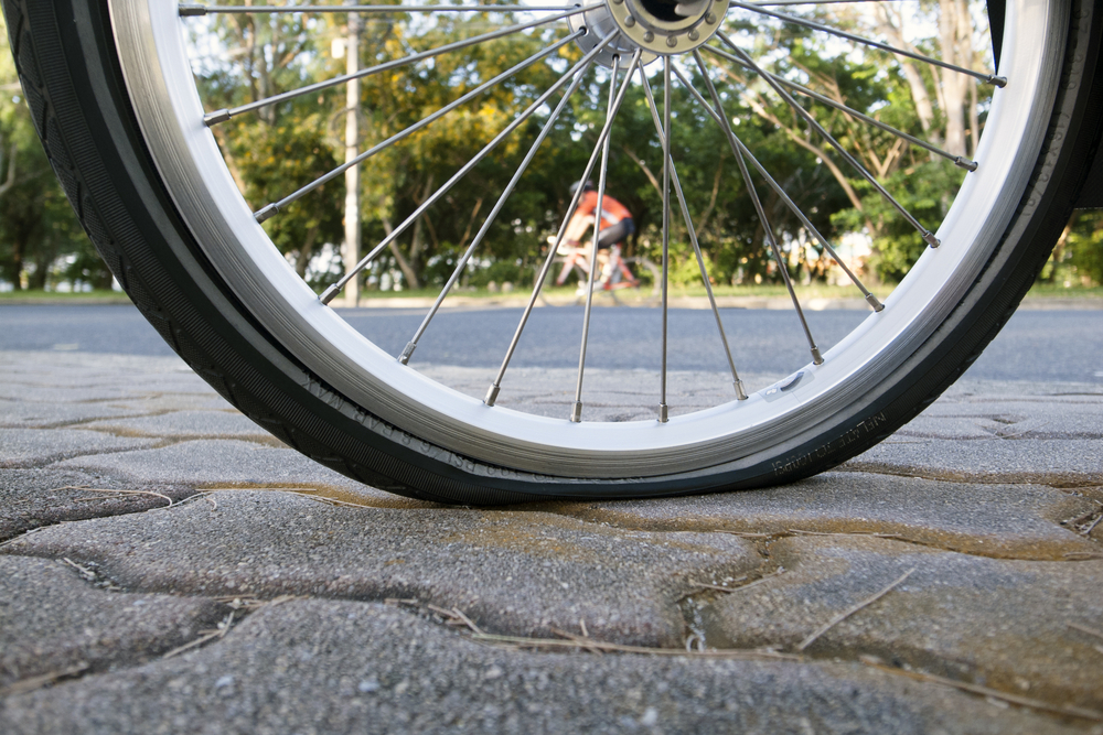 Flat,Bicycle,Tire,On,Footpath,In,The,Park